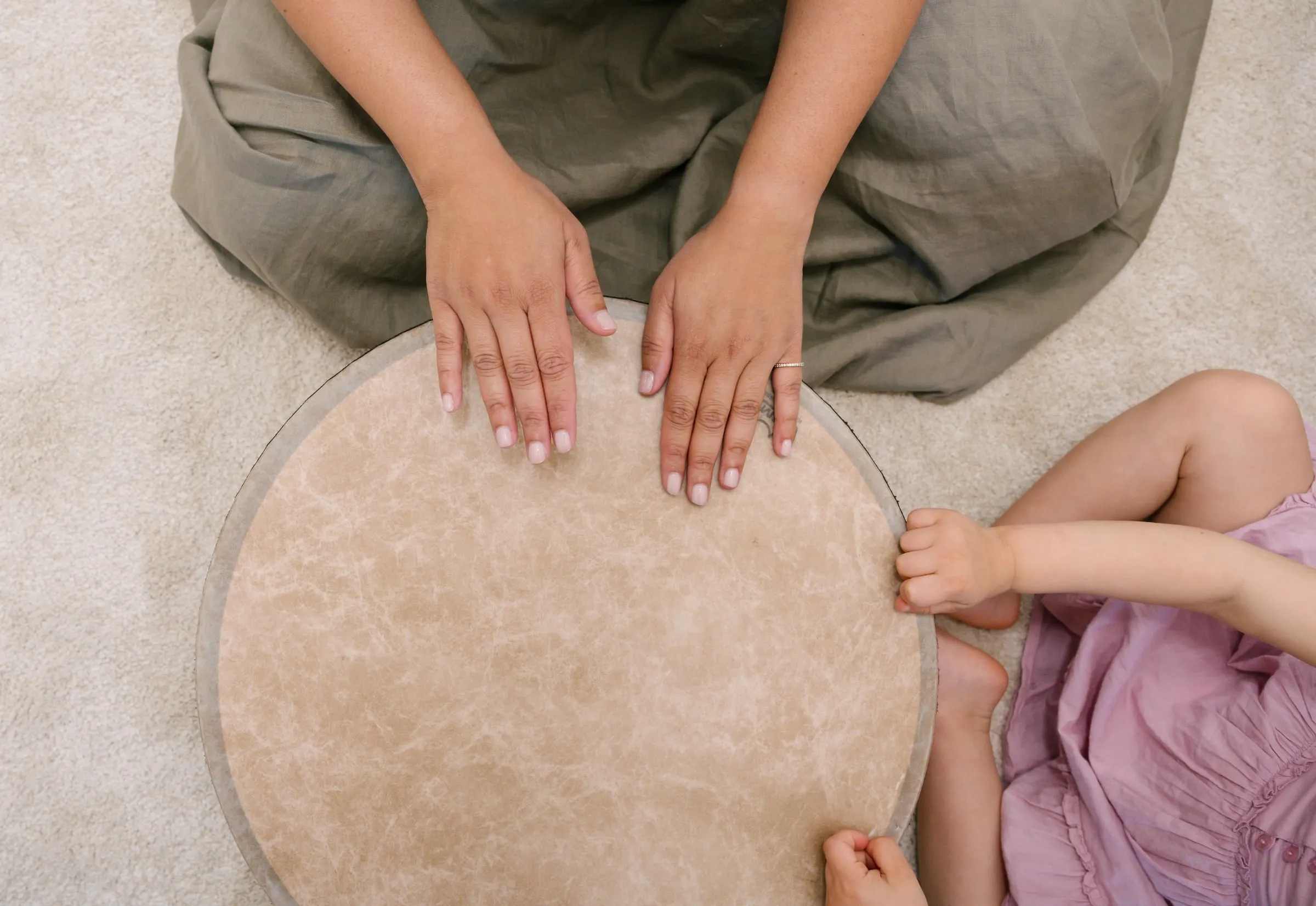 Hands on a hand drum, seen from above