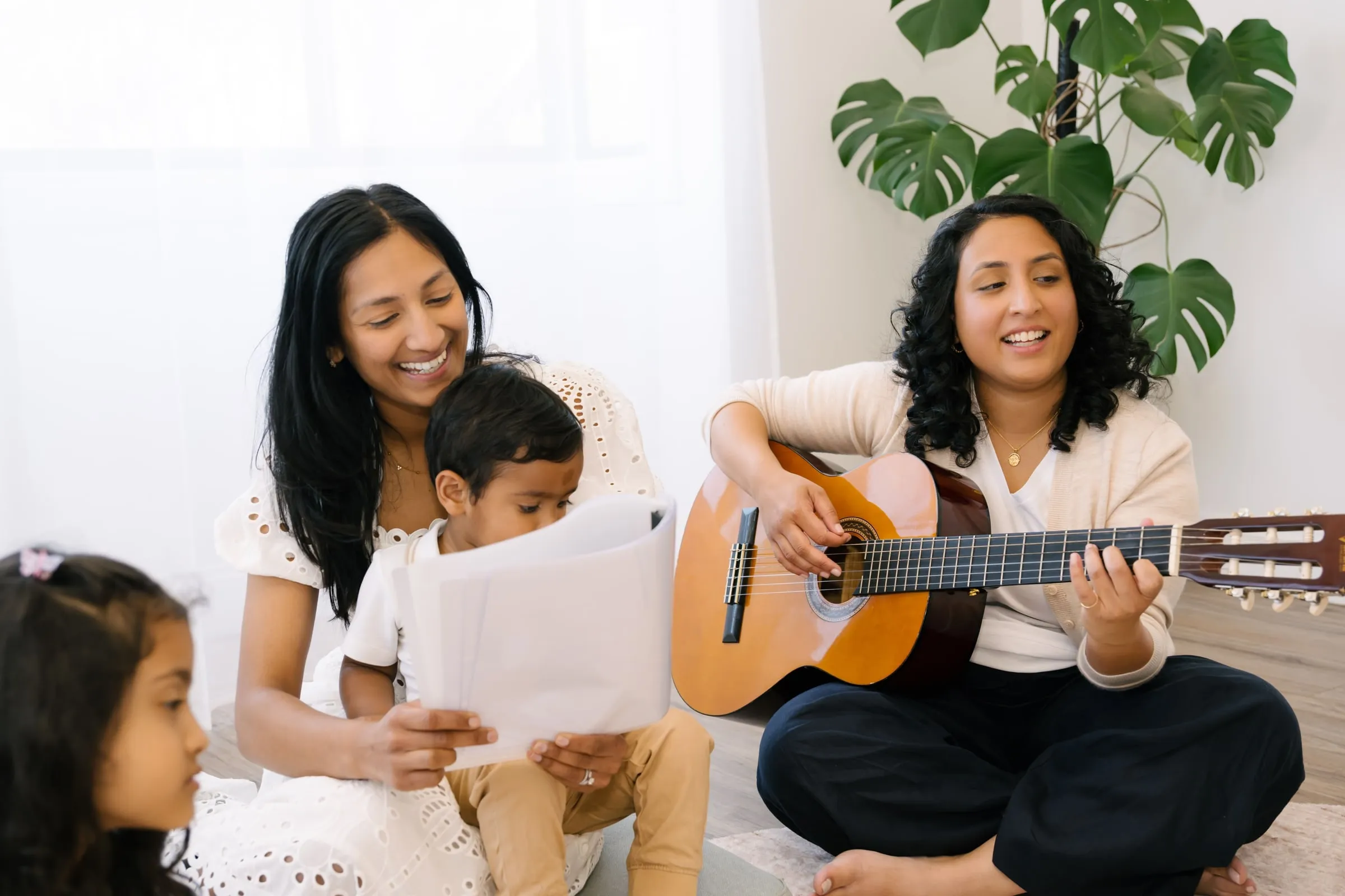 Mums singing together while Maria plays guitar